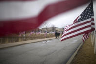 Law enforcement departments from all over the area arrive before funeral services for slain McHenry County Sheriff's Deputy Jacob Keltner on Wednesday, March 13, 2019, at Woodstock North High School in Woodstock, Ill. Keltner was shot and killed while trying to serve an arrest warrant at a hotel on March 7, 2019. (Scott P. Yates/Rockford Register Star via AP)