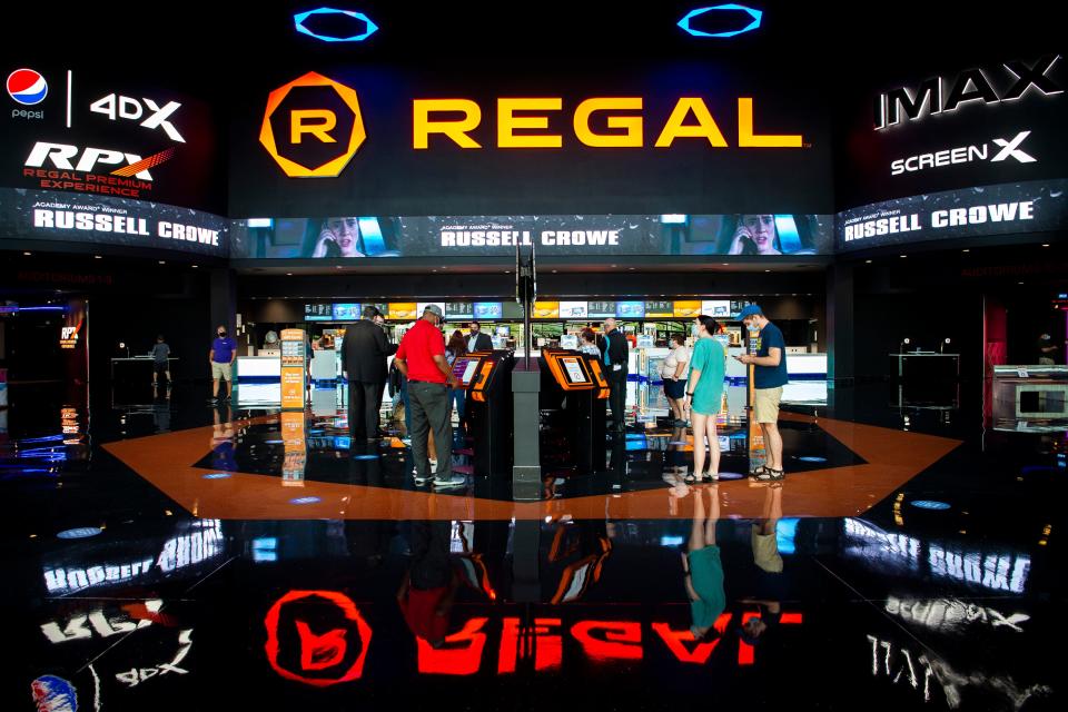 Masked moviegoers buy their movie tickets at ticket kiosks at Regal Pinnacle in Turkey Creek in August 2020. Regal Cinemas, headquartered in Knoxville, and its parent company Cineworld have not been immune to the hit the movie industry has taken since the pandemic began. Cineworld is $4.8 billion in debt, according to its most recent annual report.