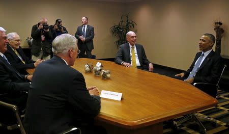 U.S. President Barack Obama (R) meets with Mormon leaders of the Church of Jesus Christ of Latter-day Saints, including President Dieter Uchtdorf (L), Elder Tom Perry (2nd L), Elder Todd Christofferson (3rd L, back to camera) and President Henry Eyring (2nd R), at Obama's hotel in Salt Lake City, Utah April 2, 2015. REUTERS/Jonathan Ernst