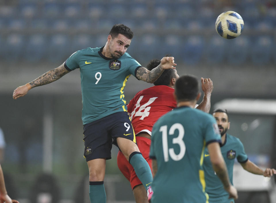 Australia's Jamie Maclaren heads the ball during the World Cup 2022 Group B qualifying soccer match between Nepal and Australia in Kuwait City, Kuwait, Friday. June 11, 2021. (AP Photo/Jaber Abdulkhaleg)