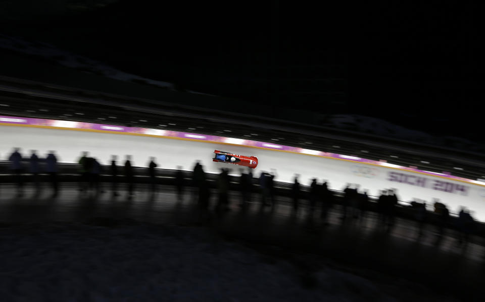 The team from Italy ITA-1, piloted by Simone Bertazzo and brakeman Simone Fontana, take a curve during the men's two-man bobsled competition at the 2014 Winter Olympics, Monday, Feb. 17, 2014, in Krasnaya Polyana, Russia. (AP Photo/Natacha Pisarenko)