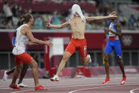 Patrick Grzegorzewicz of Poland celebrates with teammates as he crosses the finish line to win the 4 x 400-meter mixed relay at the 2020 Summer Olympics, Saturday, July 31, 2021, in Tokyo. (AP Photo/David Goldman)