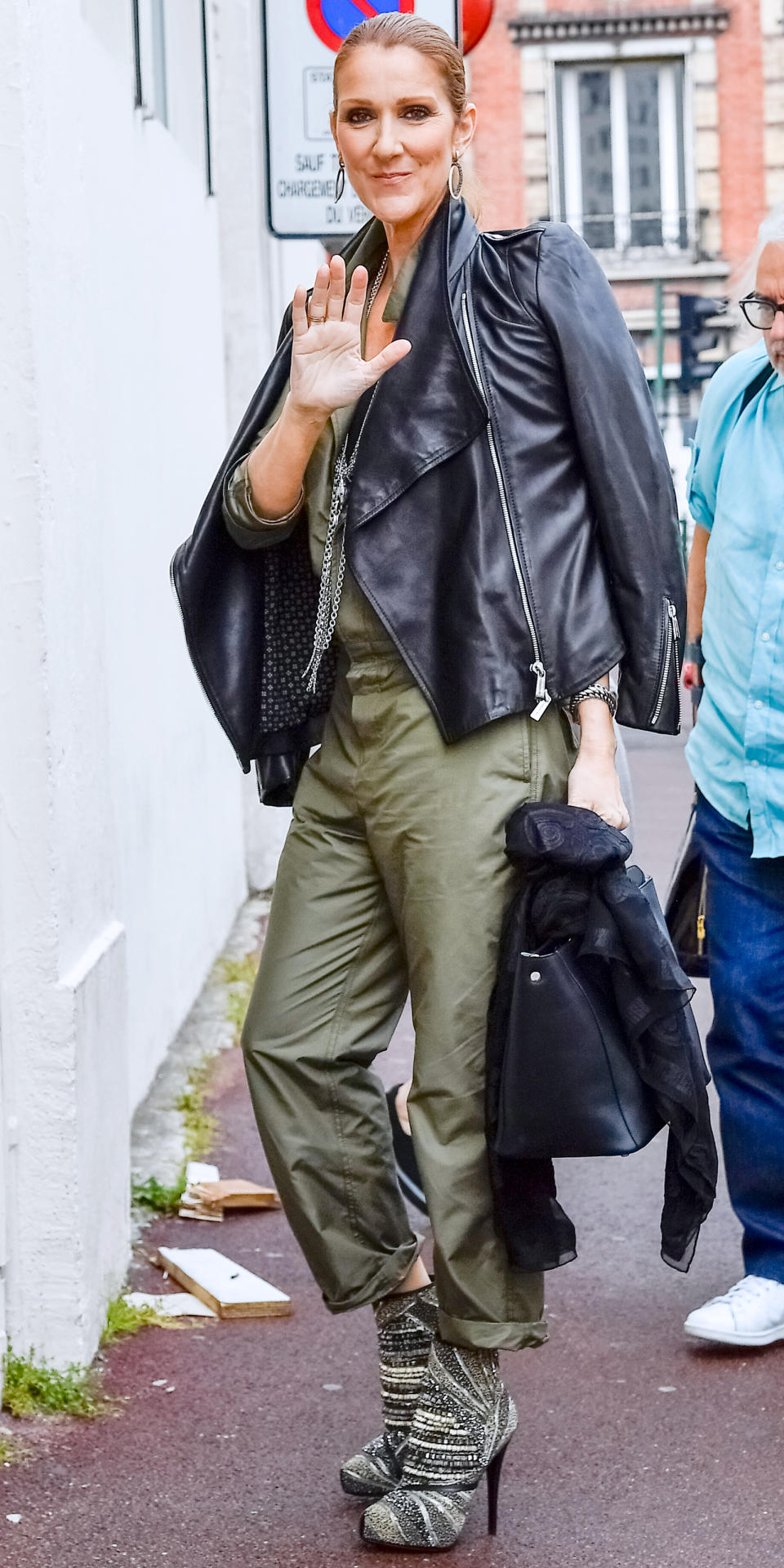 IN A MILITARY GREEN JUMPSUIT AND SPORTY LEATHER