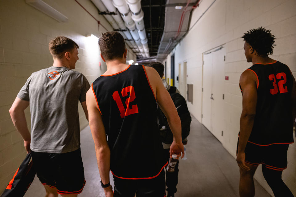 Princeton’s Blake Peters, Caden Pierce, and Keeshawn Kellman return to the locker room after a televised interview at the KFC YUM! Center in Louisville, Kentucky on March 23, 2023.<span class="copyright">Jon Cherry for TIME</span>
