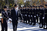 Japan's Prime Minister Fumio Kishida, second left, reviews an honor guard at the Japan Ground Self-Defense Force Camp Asaka in Tokyo, Japan, Saturday, Nov. 27, 2021. (Kiyoshi Ota/Pool Photo via AP)