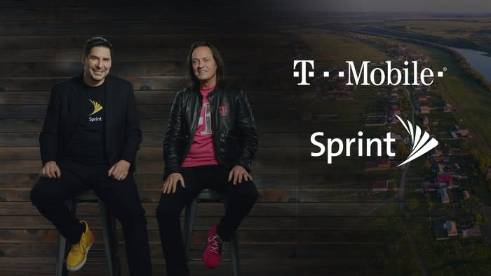 Marcelo Claure and John Legere sitting next to T-Mobile and Sprint logos