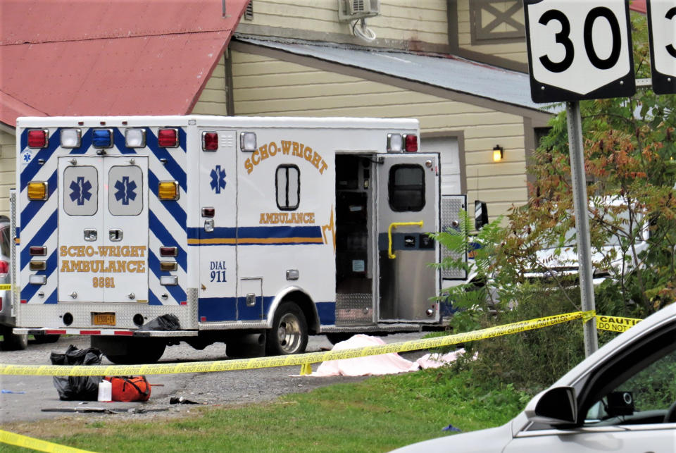 FILE - A body is draped under a blanket at the scene of a fatal crash in Schoharie, N.Y., Oct. 6, 2018. Nearly five years after catastrophic brake failure sent a stretch limousine packed with birthday revelers careening down a hill and into a shallow ravine in rural New York, killing 20 people, the operator of the company that rented out the vehicle is going on trial. Jury selection was scheduled to begin Monday, May 1, 2023, in Schoharie County Court. (Tom Heffernan Sr. via AP, File)