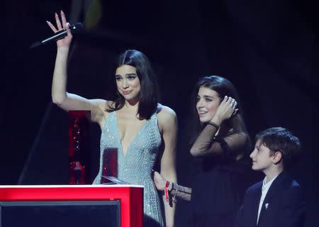 Dua Lipa accepts her award for British album with her siblings at the Brit Awards at the O2 Arena in London, Britain, February 21, 2018. REUTERS/Hannah McKay