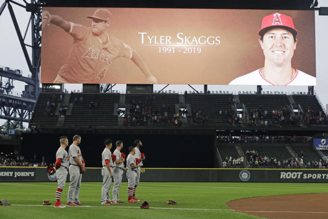 Miguel Gonzalez places a hat at a memorial for Los Angeles Angels pitcher Tyler  Skaggs outside Angel Stadium in Anaheim, Calif., Tuesday, July 2, 2019. The  27-year-old left-hander died in his Texas