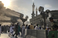 <p>Large cooling fans spray water on Muslim pilgrims around the Grand Mosque ahead of the annual Hajj pilgrimage in the Muslim holy city of Mecca, Saudi Arabia, Tuesday, Aug. 29, 2017. (Photo: Khalil Hamra/AP) </p>