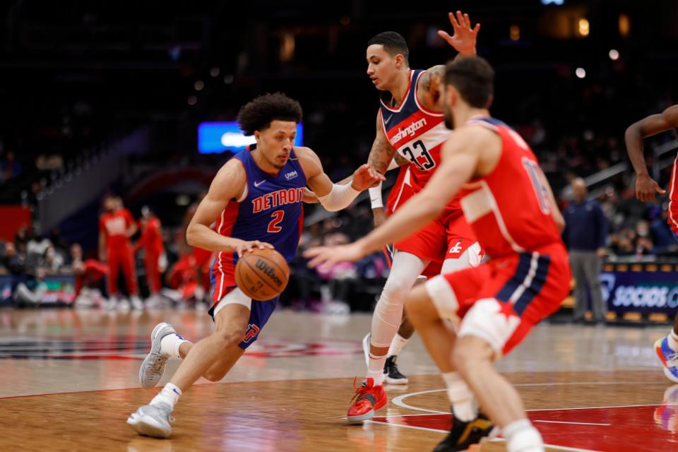 Detroit Pistons guard Cade Cunningham drives to the basket against Washington Wizards forward Kyle Kuzma (33) in the second quarter at Capital One Arena, Feb. 14, 2022.