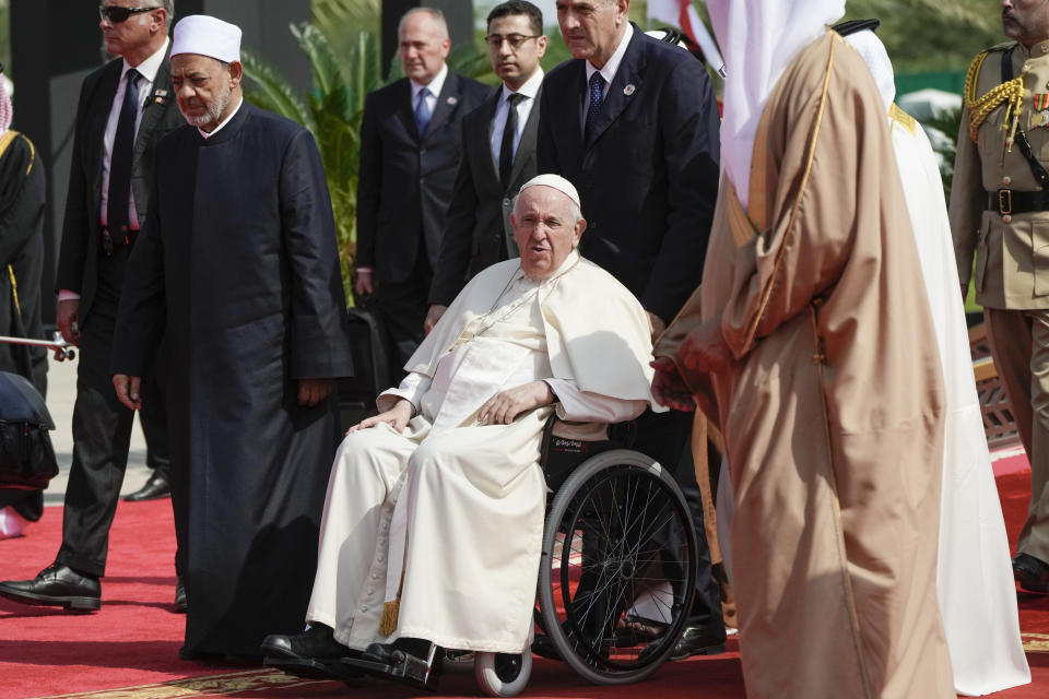 Pope Francis and Ahmed El-Tayeb, Grand Imam of al-Azhar, left, arrive for the closing session of the "Bahrain Forum for Dialogue: East and west for Human Coexistence", at the Al-Fida square at the Sakhir Royal palace, Bahrain, Friday, Nov. 4, 2022. Pope Francis is making the November 3-6 visit to participate in a government-sponsored conference on East-West dialogue and to minister to Bahrain's tiny Catholic community, part of his effort to pursue dialogue with the Muslim world. (AP Photo/Alessandra Tarantino)