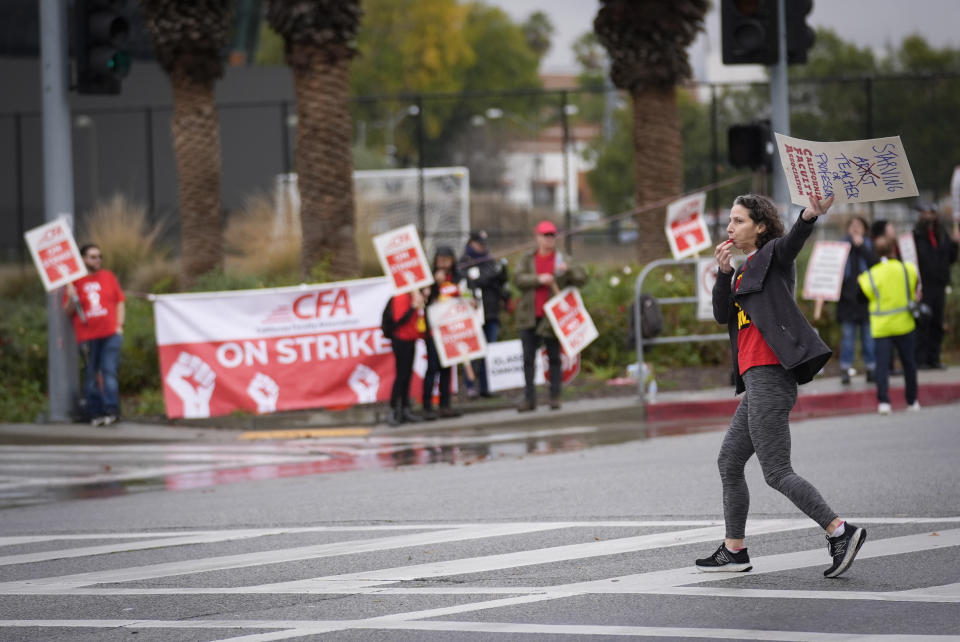 Melissa Weininger, a Jewish Studies professor, pickets outside the Cal State Northridge campus Sunday, Jan. 21, 2024, in Northridge, Calif. More than 30,000 professors, librarians, plumbers, electricians, and other workers at California State University, the largest public university system in the U.S., have started a weeklong strike on Monday to demand higher wages. (AP Photo/Marcio Jose Sanchez)