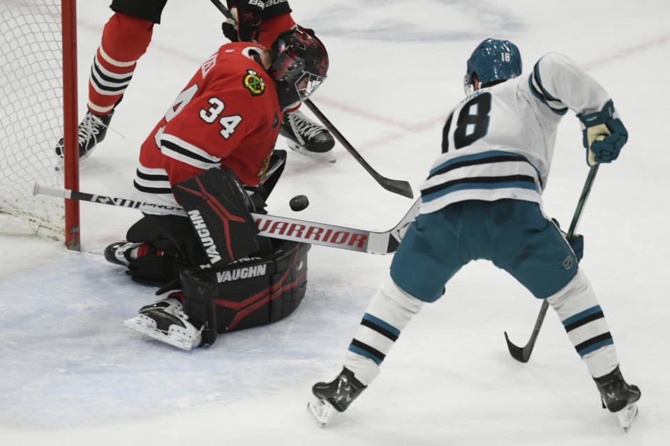 Chicago Blackhawks goalie Petr Mrazek (34) makes a save against San Jose Sharks' Filip Zadina (18) during the second period of an NHL hockey game Tuesday, Jan 16, 2024, in Chicago. (AP Photo/Paul Beaty)