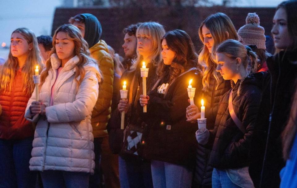 Boise State University students along with people who knew the four University of Idaho students who were found killed in Moscow pay their respects at a vigil held in front of a statue on the Boise State campus on Thursday, Nov. 17.