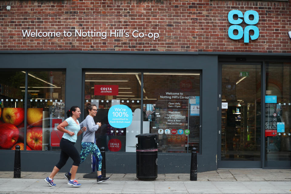 Women jog past a Co-op supermarket in London, Britain, September 14, 2018. REUTERS/Hannah McKay