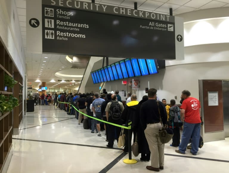 (FILES) This file photo taken on May 17, 2016 shows passengers waiting to go through security at the north terminal of Hartsfield–Jackson Atlanta International Airport in Atlanta, Georgia