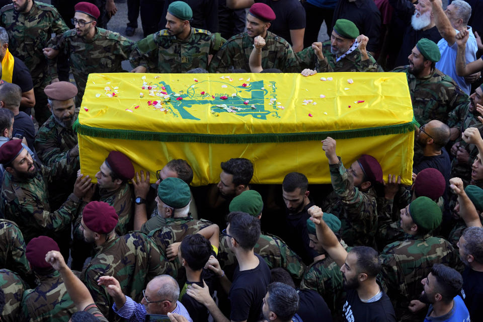 Hezbollah fighters carry the coffin of their comrade, Ali Ibrahim Rmeiti, who was killed by Israeli shelling, during his funeral procession in the southern Beirut suburb of Dahiyeh, Lebanon, Saturday, Nov. 4, 2023. (AP Photo/Bilal Hussein)