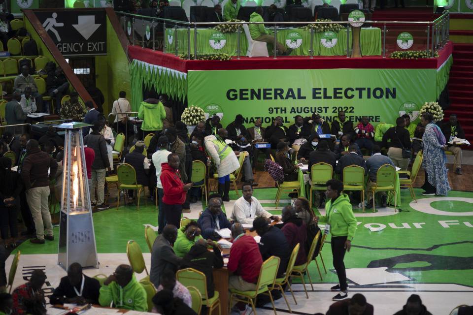 Party agents and election officials verify the vote-tallying at the Electoral Commission headquarters, in Nairobi, Kenya, Friday, Aug. 12, 2022. Vote-tallying in Kenya's close presidential election isn't moving fast enough, the electoral commission chair said Friday, while parallel counting by local media dramatically slowed amid concerns about censorship or meddling. (AP Photo/Mosa'ab Elshamy)