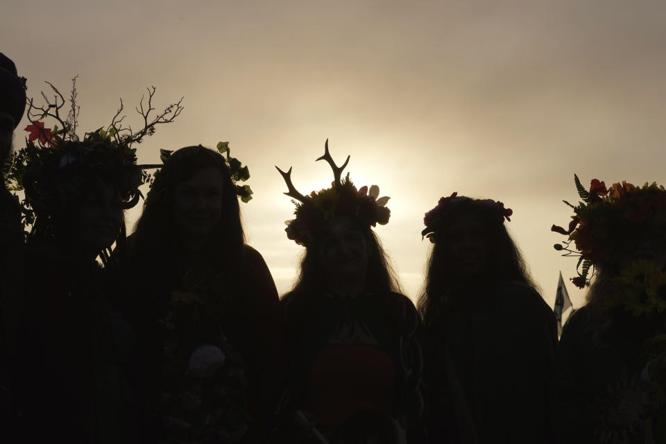 Revelers gather at the ancient stone circle Stonehenge to celebrate the Summer Solstice, the longest day of the year, near Salisbury, England, Wednesday, June 21, 2023. (AP Photo/Kin Cheung)