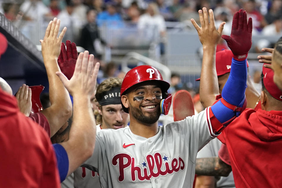 Philadelphia Phillies' Edmundo Sosa is congratulated after hitting a two-run home run during the fifth inning of a baseball game against the Miami Marlins, Sunday, July 9, 2023, in Miami. (AP Photo/Lynne Sladky)