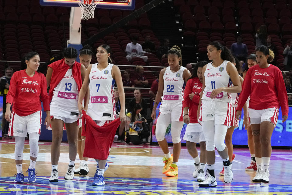 Puerto Rico players leave the court following their loss to Canada in their quarterfinal game at the women's Basketball World Cup in Sydney, Australia, Thursday, Sept. 29, 2022. (AP Photo/Mark Baker)