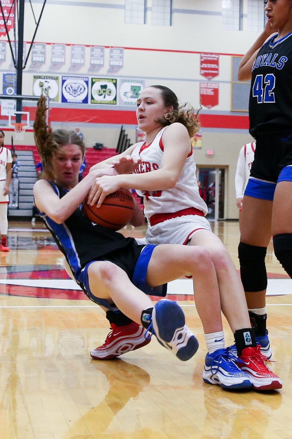 Hamilton Southeastern's Zoe Lawless (15) and Fisher's Allison Scheu (33) fight for a rebound during Fishers vs Hamilton Southeastern high school in Mudsock girls basketball held Dec 16, 2023; Fishers, IN, USA; at Fishers High School.