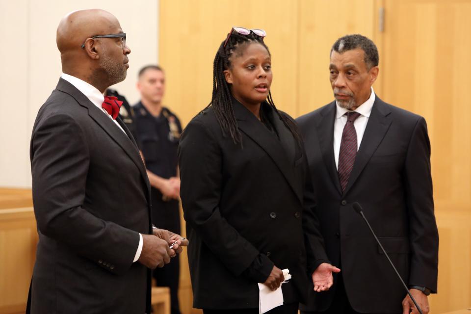 Dr. Alika Crew, center, apologizes before being sentenced to one year in jail for first-degree assault in the 2020 stabbing attack on her ex-fiance's girlfriend, Sept. 15, 2023 at Westchester County Court in White Plains. Her lawyers Anthony Ricco, left, and William Martin, right, sought leniency under state Domestic Violence Survivors Justice Act that allows mitigation if criminal conduct resulted from significant domestic abuse.