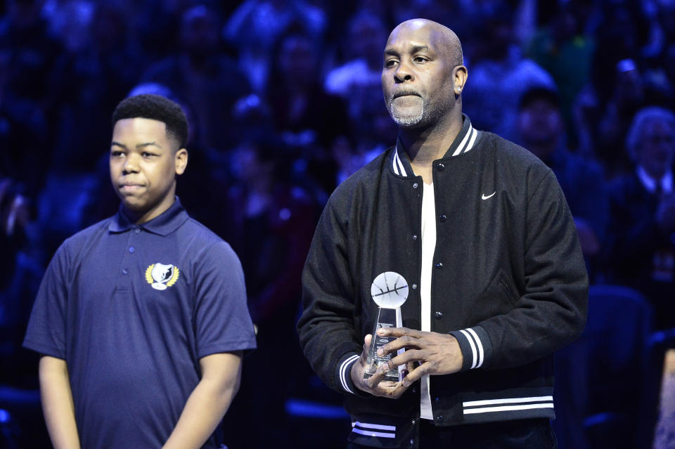 Gary Payton, right, accepts the 18th annual National Civil Rights Museum Sports Legacy Award along with fellow honorees Luol Deng, Nancy Lieberman, and Eddie George before the 21st annual Martin Luther King Jr. Day Celebration Game between the Phoenix Suns and the Memphis Grizzlies, Monday, Jan. 16, 2023, in Memphis, Tenn. (AP Photo/Brandon Dill)