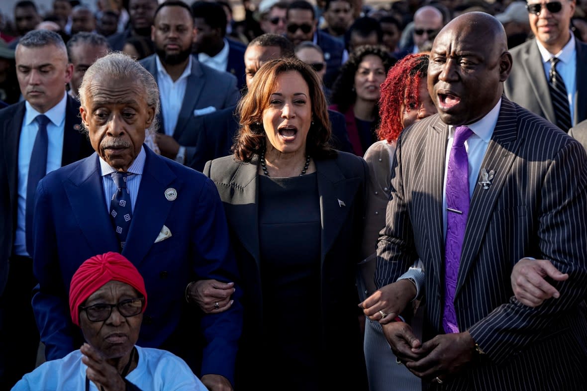 The Rev. Al Sharpton, Vice President Kamala Harris and Attorney Ben Crump walk and sing across the Edmund Pettus Bridge with others commemorating the 59th anniversary of the Bloody Sunday voting rights march in 1965, Sunday, March 3, 2024, in Selma, Ala. (Photo by Mike Stewart/AP)