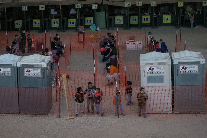 FILE PHOTO: Migrant children from Central America play in processing center under Anzalduas International Bridge in Granjeno, Texas