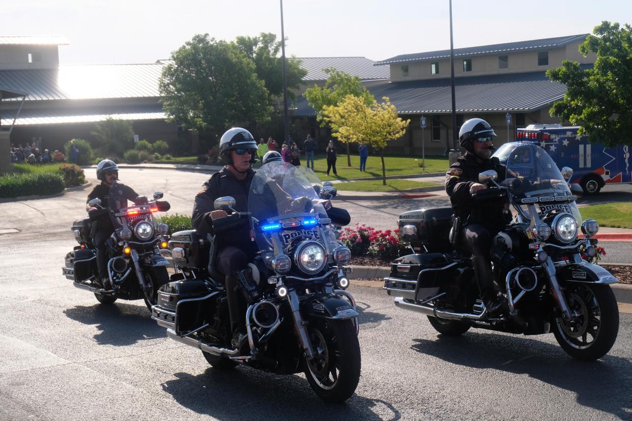Amarillo Police officers escort USS Indianapolis Survivor Cleatus Lebow from the Ussery-Roan Texas State Veterans Home Monday morning.