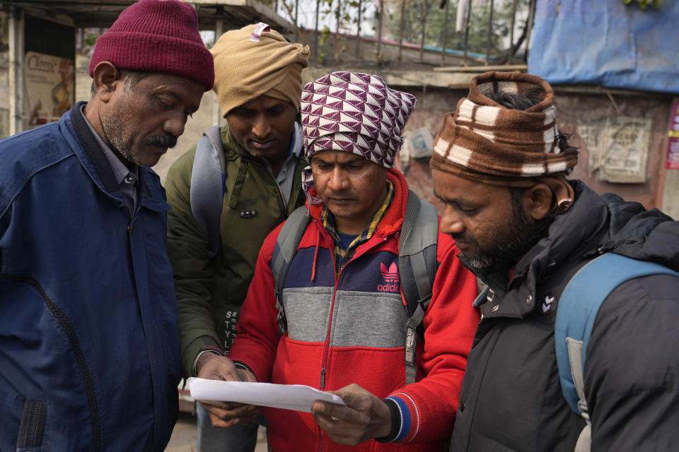 Indian workers aspiring to be hired for jobs in Israel look at a form that needs to be filled during a recruitment drive in Lucknow, India, Thursday, Jan. 25, 2024. (AP Photo/Rajesh Kumar Singh)