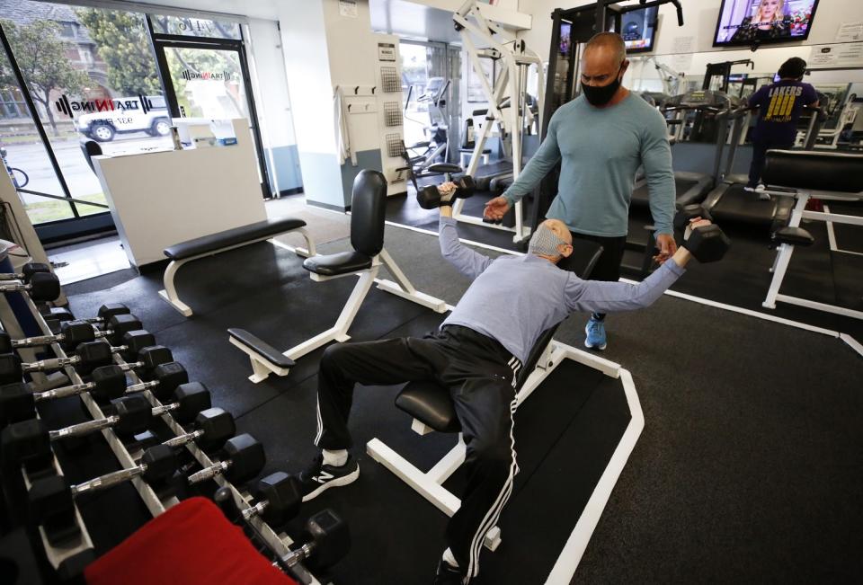 Max Baril lifts weights, spotted by Jon Aranita