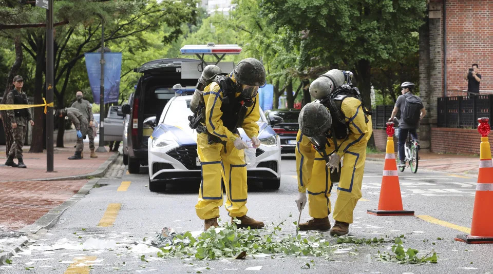 South Korean army soldiers wearing protective gear checks the debreis from a balloon presumably sent by North Korea, Wednesday, July 24, 2024, in Seoul, South Korea. (Park Dong-joo/Yonhap via AP)