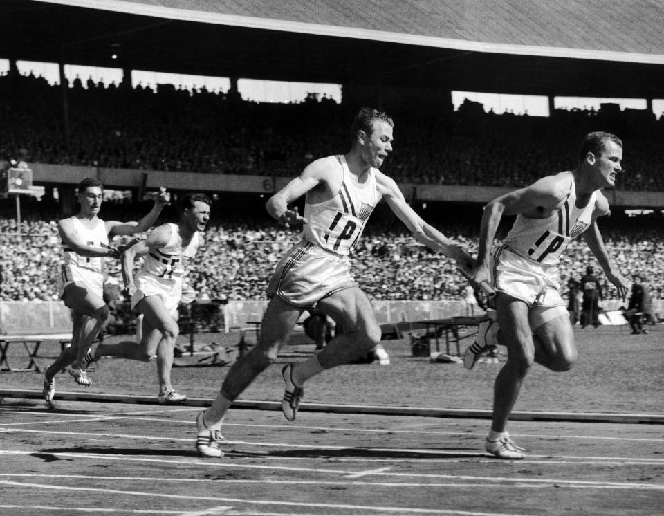 FILE - In this Nov. 30, 1956, file photo, Thane Baker, of the United States, hands to Bobby Joe Morrow for the last baton change in the first heat of the first round of the 4 x 100 meters Summer Olympic Games relay event in Melbourne, Australia. Morrow, the Texas sprinter who won three gold medals in the 1956 Melbourne Olympics while a student at Abilene Christian University, died Saturday, May 30, 2020. He was 84. (AP Photo/Pool, File)