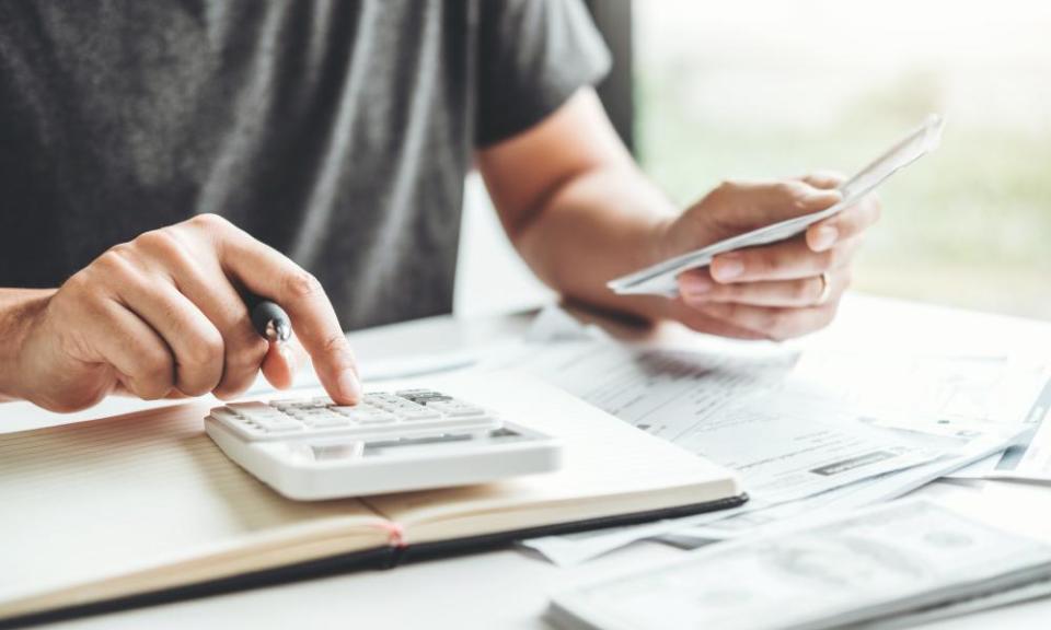 Man using calculator Accounting Calculating Cost Economic bills