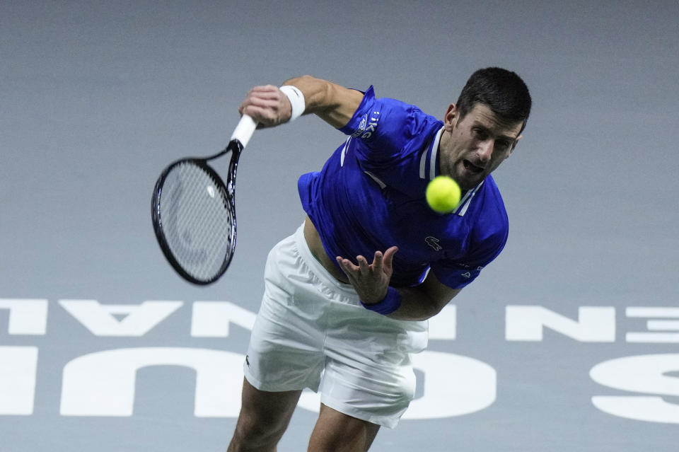 Serbia's Novak Djokovic serves the ball to Croatia's Marin Cilic during their Davis Cup tennis semi-final match at Madrid Arena in Madrid, Spain, Friday, Dec. 3, 2021. (AP Photo/Bernat Armangue)