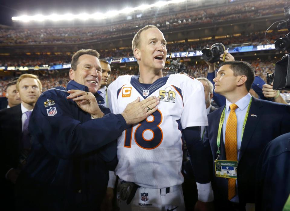 Denver Broncos' head coach Gary Kubiak (L) and quarterback Peyton Manning celebrate after their team defeated the Carolina Panthers in the NFL's Super Bowl 50 football game in Santa Clara, California February 7, 2016. REUTERS/Mike Blake