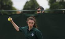 A spectator looks over a barrier to watch the singles match between Portugal's Michelle Larcher De Brito and Belgium's Ysaline Bonaventure during the Wimbledon Tennis Championships qualifying rounds at the Bank of England Sports Centre in Roehampton, southwest London, Britain June 23, 2015. REUTERS/Suzanne Plunkett