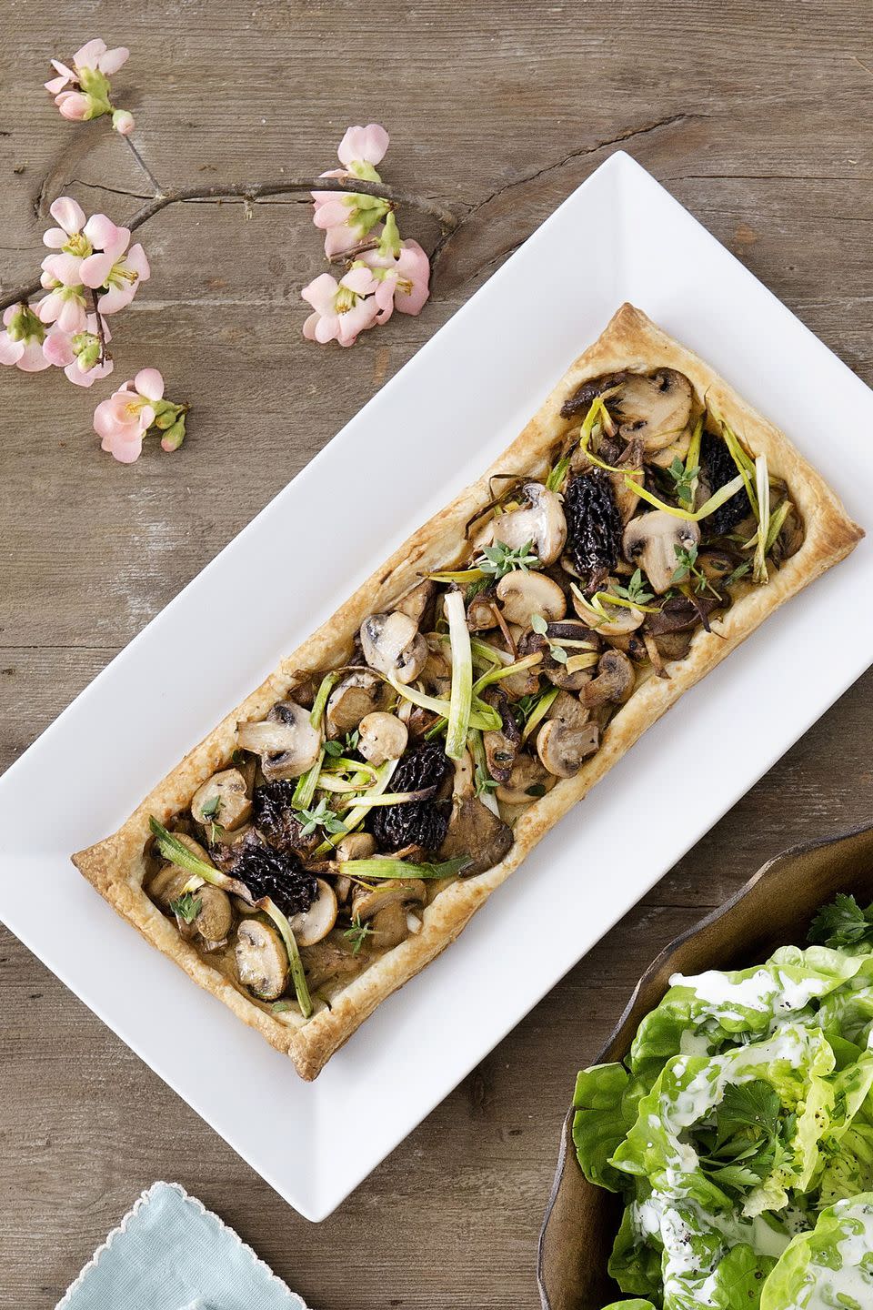 long rectangular mushroom and leek tart on a white rectangle plate