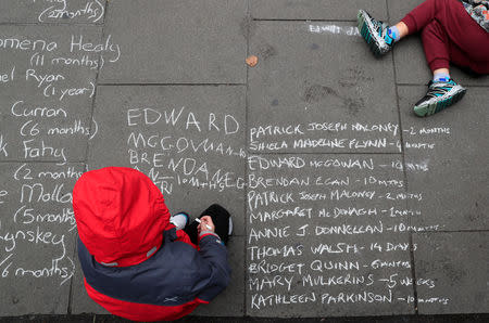 A child writes with chalk as people take part in a protest during the visit of Pope Francis to Dublin, Ireland, August 26, 2018. REUTERS/Gonzalo Fuentes