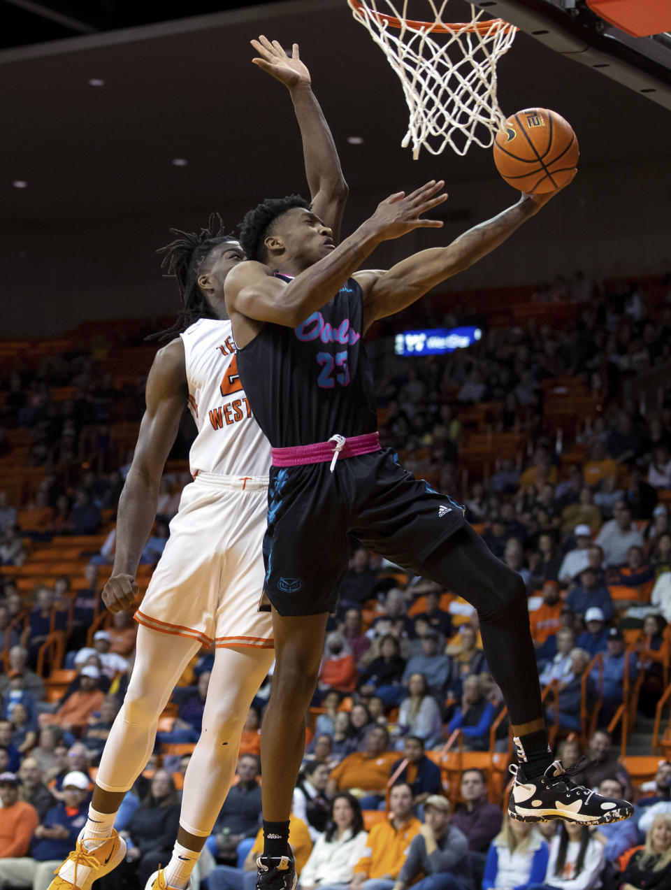 Florida Atlantic forward Tre Carroll (25) drives for a layup as UTEP forward Ze'Rik Onyema defends during the second half of an NCAA college basketball game Saturday, Jan. 21, 2023, in El Paso, Texas. (AP Photo/Andrés Leighton)