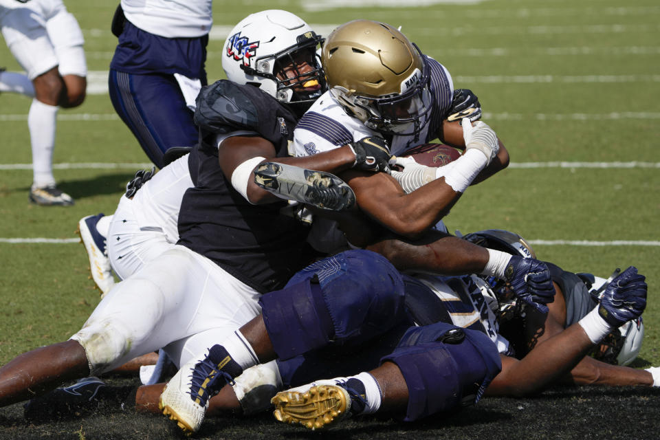 Navy wide receiver Vincent Terrell Jr. scores a touchdown past the Central Florida defense during the first half of an NCAA college football game, Saturday, Nov. 19, 2022, in Orlando, Fla. (AP Photo/John Raoux)