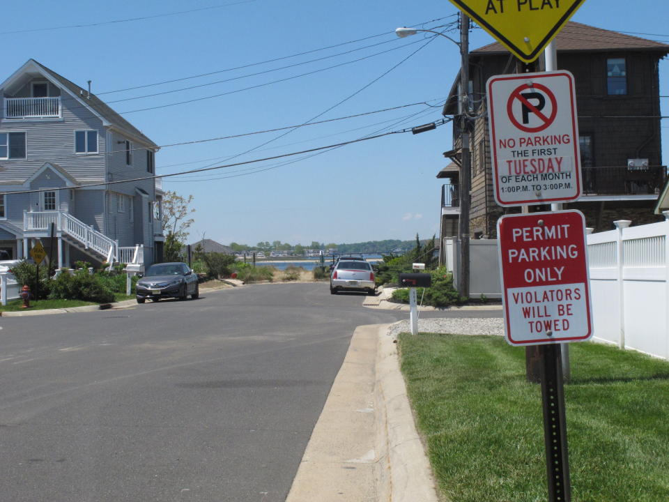 A sign is displayed on a side street in Sea Bright N.J. on May 15, 2021, restricting parking to those with a permit. Some shore towns in New Jersey and other states have used parking restrictions as a way to keep outsiders off their beaches. Sea Bright does offer a public parking lot near one beach. (AP Photo/Wayne Parry)