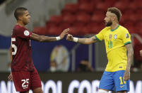 Brazil's Neymar, right, and Venezuela's Richard Celis greet each other with social distance at the end of a Copa America soccer match at the National Stadium in Brasilia, Brazil, Sunday, June 13, 2021. (AP Photo/Eraldo Peres)