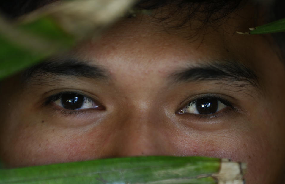 In this Jan. 27, 2019, photo, a former altar boy poses for a portrait in Talustusan on Biliran Island in the central Philippines. In December 2018, the 23-year-old went to the police and the village's Catholic parish priest Father Pius Hendricks was arrested and charged with child abuse. "I asked why he was doing this to me," describing how Hendricks would take him into the bathroom of the little rectory, just a few steps from the rebuilt chapel and sexually assault him. (AP Photo/Bullit Marquez)