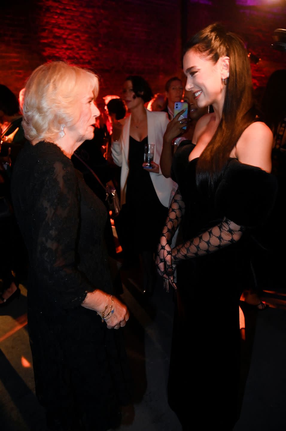 london, england   october 17 camilla, queen consort meets singer dua lipa at the 2022 booker prize for fiction ceremony at the roundhouse, on october 17, 2022, in london, england photo by toby melville   wpa poolgetty images