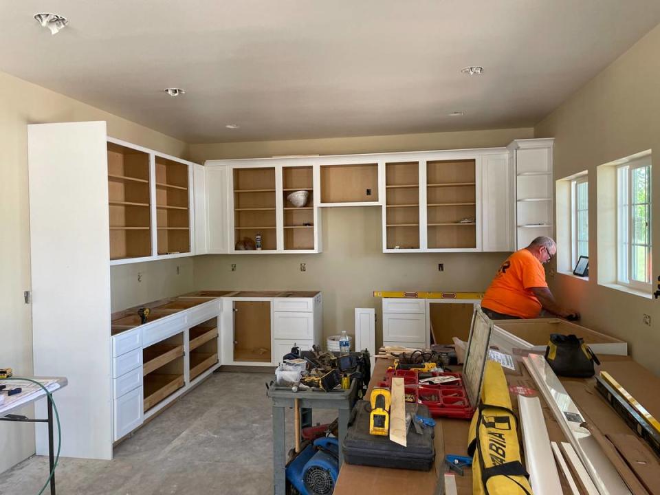 Builder from Red River Construction works on cabinets in the kitchen of Burt and Aurora Skurtun’s ADU in Patterson on Friday, April 19, 2024 Maria Figueroa mfigueroa@modbee.com