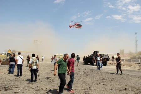 An ambulance helicopter takes off from the blast scene where two officers and one civilian were killed when a car bomb exploded outside a police station near Turkey's southeastern city of Diyarbakir, Turkey August 15, 2016. REUTERS/Ihlas News Agency via REUTERS